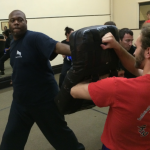 Kung Fu Student Punches Bag